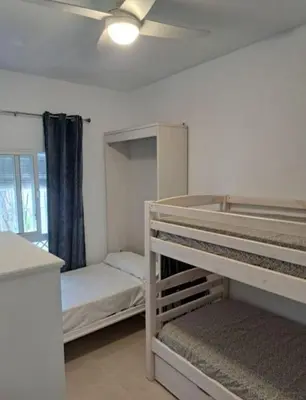 a bedroom with two bunk beds and a ceiling at Doña Violeta - La Barrosa in Novo Sancti Petri