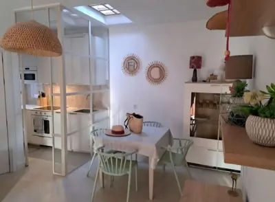 a kitchen with a table and chairs in a room at Doña Violeta - La Barrosa in Novo Sancti Petri
