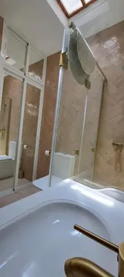 a bathroom with a white tub and a mirror at Doña Violeta - La Barrosa in Novo Sancti Petri