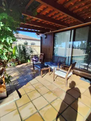 a patio with two chairs and a bench on it at Brisa&Mar in Chiclana de la Frontera