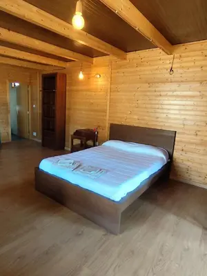 a bedroom with a bed in a wooden room at Brisa&Mar in Chiclana de la Frontera