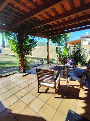 a bench sitting under a pavilion on a patio at Brisa&Mar in Chiclana de la Frontera