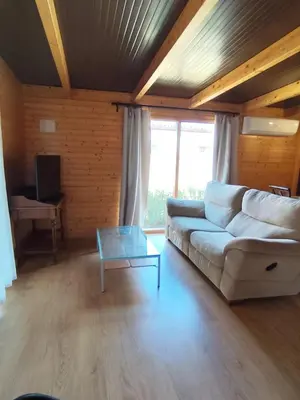 a living room with a white couch and a glass table at Brisa&Mar in Chiclana de la Frontera