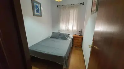 a small bedroom with a bed and a window at Costa Playasol in Novo Sancti Petri