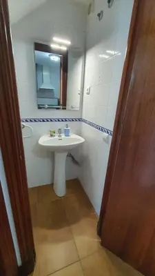 a bathroom with a white sink and a mirror at Costa Playasol in Novo Sancti Petri