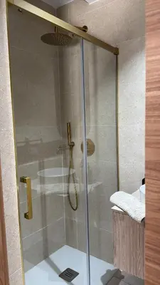 a shower with a glass door in a bathroom at Casa Isabel in Chipiona
