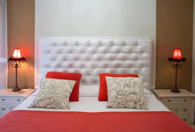 a bedroom with a large white bed with two lamps at Villa de Lujo con Jardines y Piscina in El Puerto de Santa María