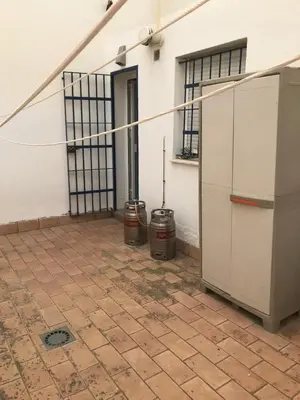 a room with two trash cans next to a building at Atardeceres en Bajoguía in Sanlúcar de Barrameda