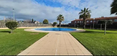 a swimming pool in a park with palm trees at Atardeceres en Bajoguía in Sanlúcar de Barrameda