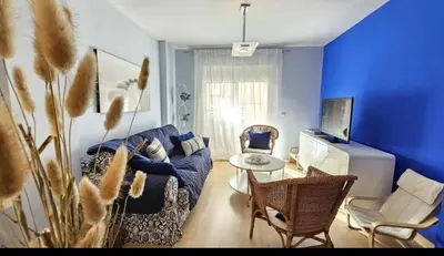 a blue living room with a couch and a table at Atardeceres en Bajoguía in Sanlúcar de Barrameda