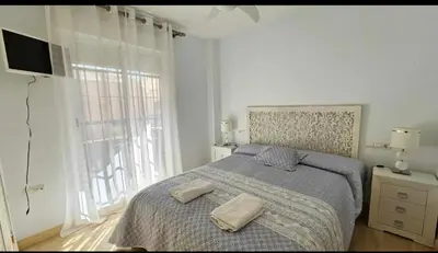 a bedroom with a bed with two towels on it at Atardeceres en Bajoguía in Sanlúcar de Barrameda