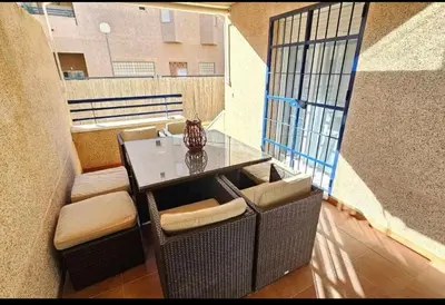 a balcony with a table and chairs on a balcony at Atardeceres en Bajoguía in Sanlúcar de Barrameda