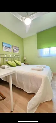 a large bed in a room with green walls at Atardeceres en Bajoguía in Sanlúcar de Barrameda