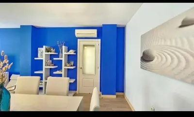 a blue room with white chairs and a blue wall at Atardeceres en Bajoguía in Sanlúcar de Barrameda