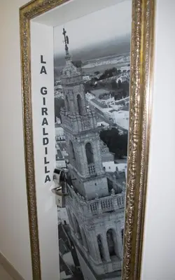 a picture of a building in a gold frame at Hotel Barrio Nuevo in Lebrija