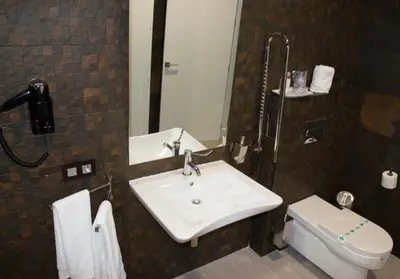 a bathroom with a sink and a toilet at Hotel Barrio Nuevo in Lebrija