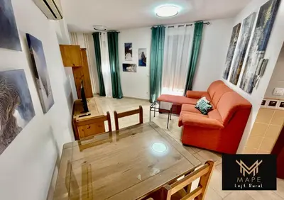a living room with a red couch and a table at Mape Loft Rural El MIMBRAL in Algar