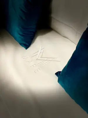a piece of paper on a bed next to a pillow at Mape Loft Rural El MIMBRAL in Algar