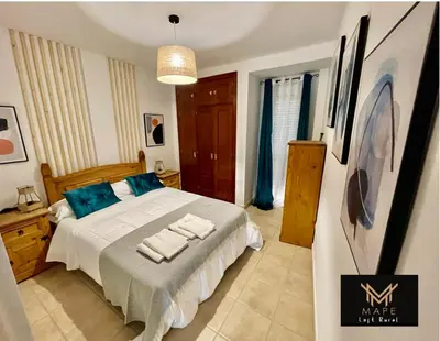 a bedroom with a bed with towels on it at Mape Loft Rural El MIMBRAL in Algar