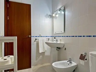 a bathroom with a sink and a toilet and a mirror at El Compás de Jerez - Ole Solutions in Jerez de la Frontera