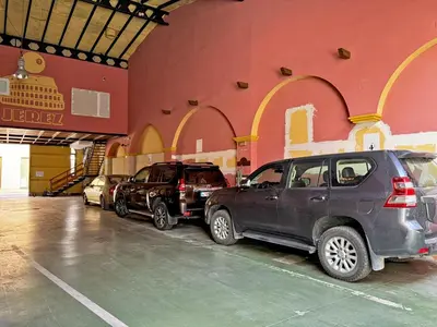 a parking lot with cars parked in front of a building at El Compás de Jerez - Ole Solutions in Jerez de la Frontera