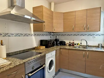a kitchen with a washing machine and a sink at El Compás de Jerez - Ole Solutions in Jerez de la Frontera