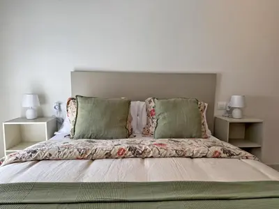 a bedroom with a bed with two pillows at El Compás de Jerez - Ole Solutions in Jerez de la Frontera