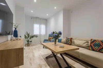 a living room with a couch and a table at Paseo Maritimo 3 Dormitorios in Cádiz