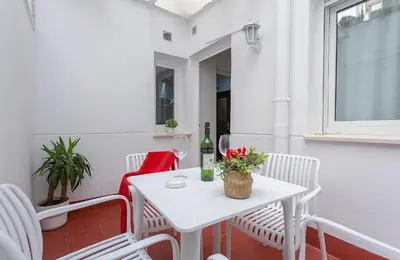 a small white table and chairs on a balcony at Paseo Maritimo 3 Dormitorios in Cádiz