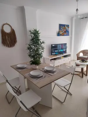 a dining room with a table and chairs at Piso a estrenar en el pintoresco Barrio Alto in Sanlúcar de Barrameda