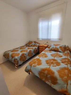 two beds sitting next to each other in a bedroom at Piso a estrenar en el pintoresco Barrio Alto in Sanlúcar de Barrameda