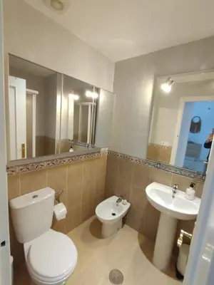 a bathroom with a toilet and a sink at Piso a estrenar en el pintoresco Barrio Alto in Sanlúcar de Barrameda