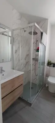 a bathroom with a shower and a sink and a toilet at Villa Brinco in Chipiona