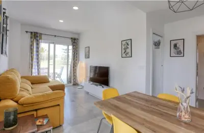a living room with a couch and a table at Casa Rosado Beautiful House and 60 m of Private Garden in Conil de la Frontera
