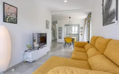 a living room with a couch and a tv at Casa Rosado Beautiful House and 60 m of Private Garden in Conil de la Frontera