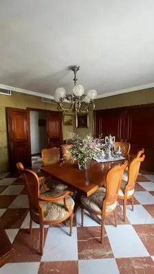 a dining room with a wooden table and chairs at Apartamento centrico, 5 bedrooms, 5 baños en-suite in Jerez de la Frontera