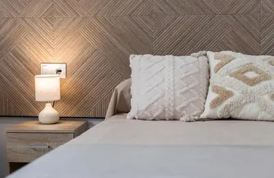 a bed with a white pillow and a lamp at Holiday Homes - Los Ángeles de Costa Ballena in Chipiona