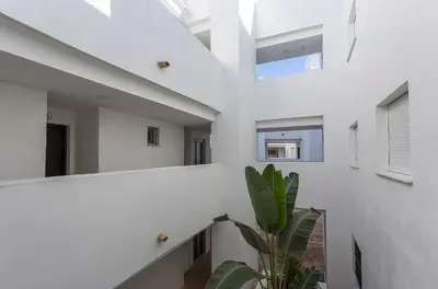 a staircase in a white building with a plant at Holiday Homes - Los Ángeles de Costa Ballena in Chipiona