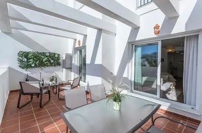 a dining room with a glass table and chairs at Holiday Homes - Los Ángeles de Costa Ballena in Chipiona