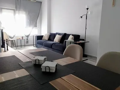 a living room with a couch and a table at Light and spacious apartment in the heart of San Fernando, Cádiz in San Fernando