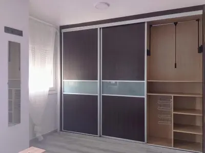 a large closet with glass doors in a room at Light and spacious apartment in the heart of San Fernando, Cádiz in San Fernando