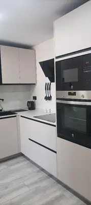 a kitchen with white cabinets and a black microwave at Light and spacious apartment in the heart of San Fernando, Cádiz in San Fernando