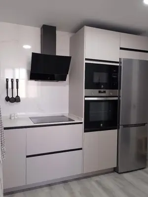 a white kitchen with a stove and a refrigerator at Light and spacious apartment in the heart of San Fernando, Cádiz in San Fernando
