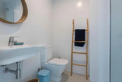 a bathroom with a toilet and a sink and a mirror at Holiday Homes - Ocean Costa Ballena in Cádiz