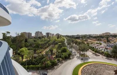 a view of a city street with trees and buildings at Holiday Homes - Sky Garden Jerez in Jerez de la Frontera