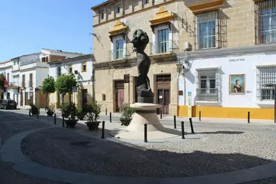 a building with a clock tower on the side of a street at Holiday Homes - Sky Garden Jerez in Jerez de la Frontera