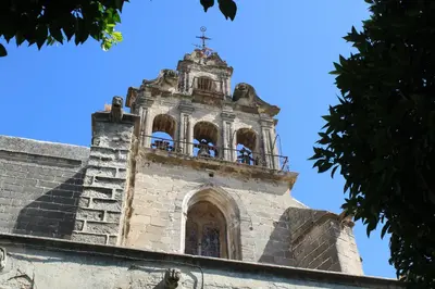 an empty street with a building with a clock tower at Holiday Homes - Sky Garden Jerez in Jerez de la Frontera
