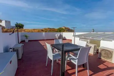 a patio with a table and chairs on a balcony at Villa Stella maison entre Séville et Cadix in Lebrija