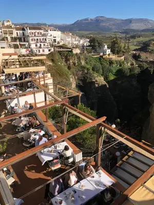 a group of people sitting at tables on a mountain at Villa Stella maison entre Séville et Cadix in Lebrija