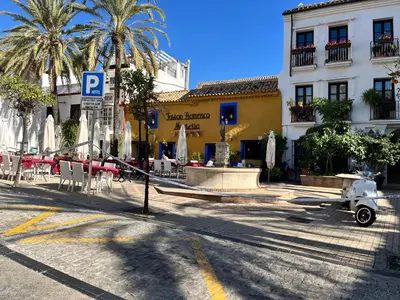 a street with tables and chairs and a building at Villa Stella maison entre Séville et Cadix in Lebrija